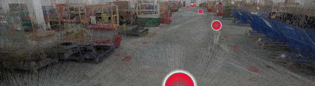 DroneDeploy LiDAR point-cloud scan output of a commercial construction site interior, showing dense scan data with materials and equipment visible, overlaid with red circular pin markers indicating annotated locations or detected items along the scan path