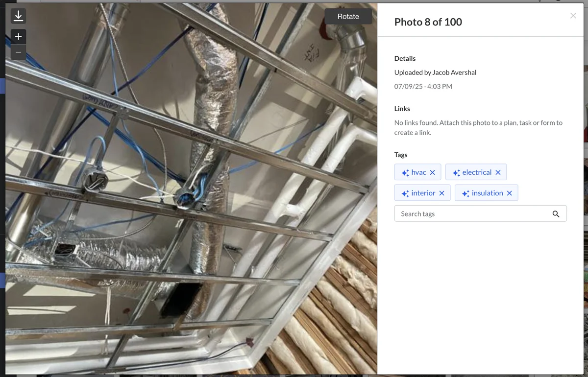 Fieldwire AI photo tagging interface showing a photo of overhead HVAC ductwork with auto-suggested tags: hvac, electrical, interior, insulation displayed in the right panel with search box for adding more tags